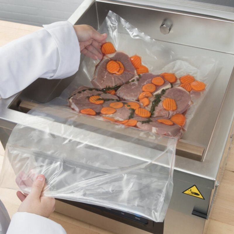 Clear vacuum bag going into a chamber sealer